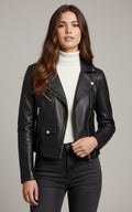 Woman wearing a black leather jacket over a white turtleneck on a gray background